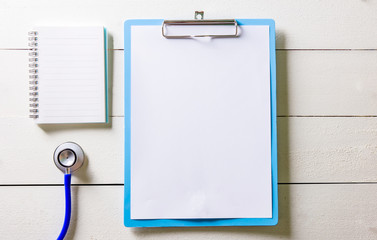 Empty clipboard with Stethoscope on wood table