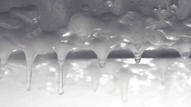 Water drop on ice icicles in macro
