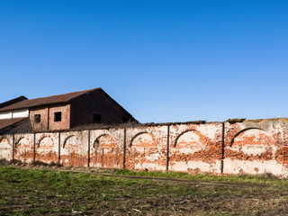 Fototapeta na wymiar red brick fence wall of a farm