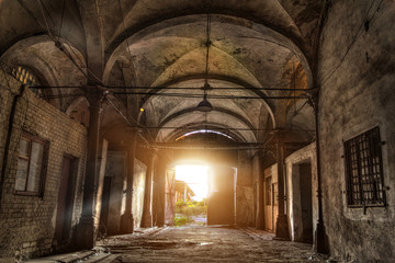 Fototapeta na wymiar Old abandoned industrial building with vaulted celling in Gothic style. Abandoned German meat processing plant Rosenau 