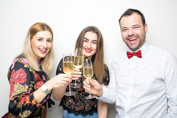 three people girls man posing party props photo booth white plain background studio hat