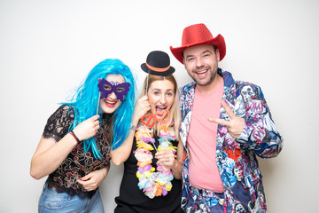 three people girls man posing party props photo booth white plain background studio hat