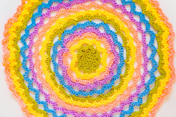 Color striped crocheted crochets. White background.