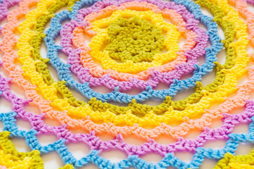 Color striped crocheted crochets. White background.