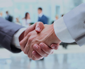 Close up of businessmen shaking hands.