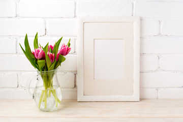 White frame mockup with pink tulips in glass vase