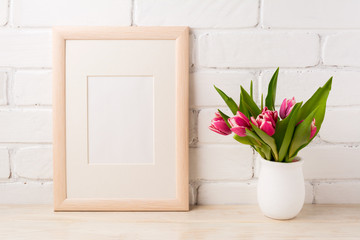 Wooden frame mockup with magenta tulips bouquet