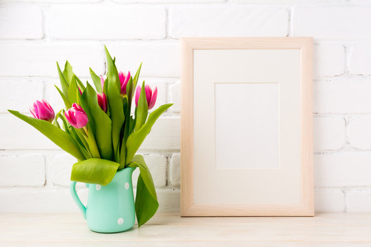 Wooden frame mockup with pink tulips in jug