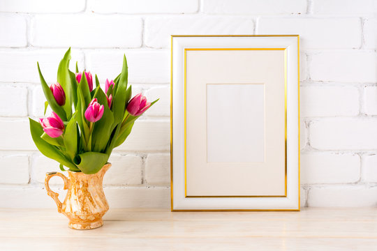 Gold decorated frame mockup with pink tulips in jug