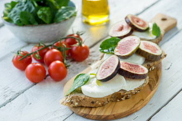 fresh ripe sliced fig on toast bread mozzarella cheese Italian crostini dish light lunch starter