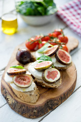 fresh ripe sliced fig on toast bread mozzarella cheese Italian crostini dish light lunch starter