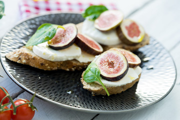 fresh ripe sliced fig on toast bread mozzarella cheese Italian crostini dish light lunch starter