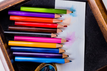 Row of assorted colored pencils in a drawer