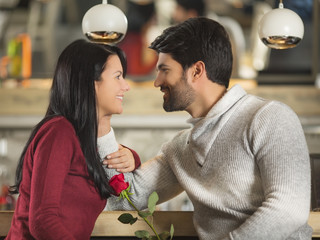 Young couple with a red rose celebrating Valentine's day