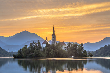 Famous Lake bled with church under orange morning sky