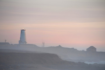 Misty sunset at Piadras Blancas Lighthouse along the coast in Northern California.