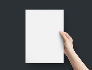 Woman hand holding blank paper sheet A4 size.