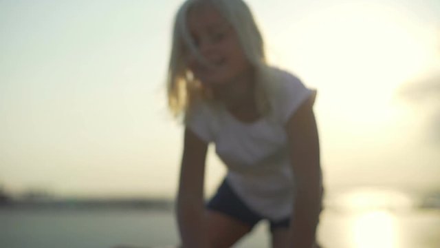 Portrait of happy blonde baby girl sunset rapid slow motion