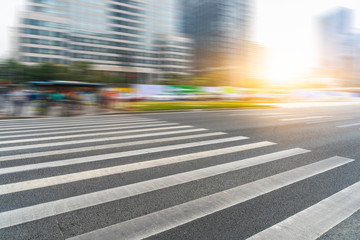 empty road with zebra crossing and skyscrapers in modern city.