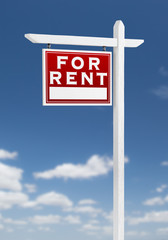 Left Facing For Rent Real Estate Sign on a Blue Sky with Clouds.