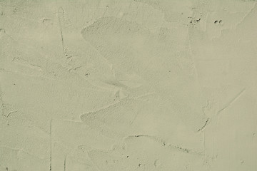 the unfinished  brown cement wall background with the vestige of plastering