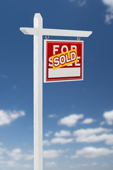 Right Facing Sold For Sale Real Estate Sign on a Blue Sky with Clouds.
