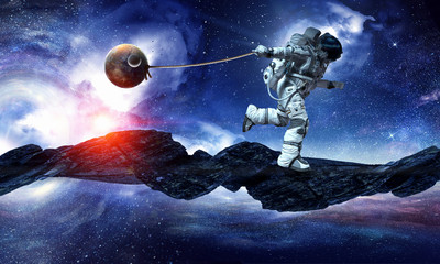 Fototapeta na wymiar Fantasy image with spaceman catch planet. Mixed media