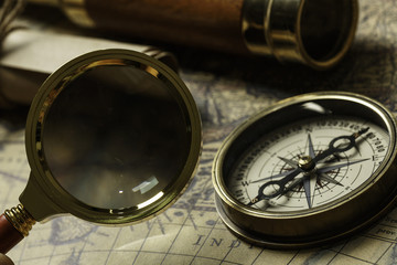 Retro compass with old map and spyglass