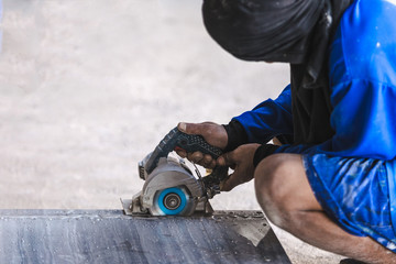 Fototapeta premium Man professional worker cutting tile