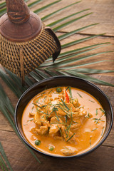 Thai curry red soup,Thailand tradition red curry with beef,pork or chicken menu in thai name is panaeng.Curry menu with coconut milk.Panaeng Curry on Wooden table