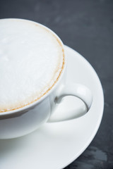 Cup of coffee on the rustic wooden background. Selective focus. Shallow depth of field.