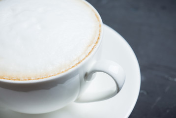 Cup of coffee on the rustic wooden background. Selective focus. Shallow depth of field.