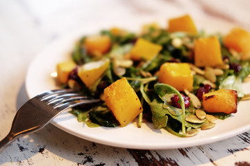 salad with pumpkin, pumpkin seeds and arugula