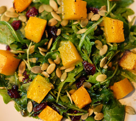 salad with pumpkin, pumpkin seeds and arugula