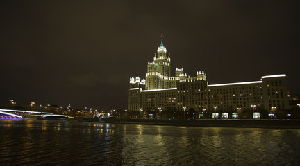 Fototapeta na wymiar Winter Night View of Moscow River and skyscraper on Kotelnicheskaya with evening illumination