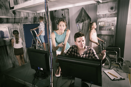 Family using PC in escape room under laboratory