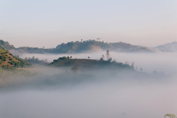 Obraz na płótnie Canvas Fog path through the mountain farm uphill to the sky at morning time.