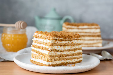 Honey layered cake or russian cake Medovik on white plate. Closeup view, selective focus