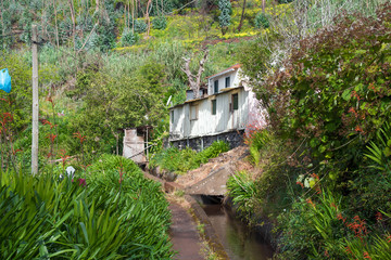 Levada trail with a wayside house. Leavdas are irrigation channels specific to the island of Madeira often with a public footpath on the side.