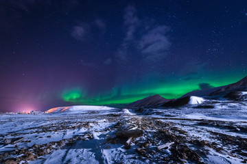 Fototapeta na wymiar The polar arctic Northern lights aurora borealis sky star in Norway Svalbard in Longyearbyen city town mountains