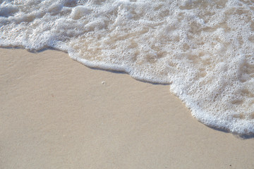 The movement of the waves on the sand is smooth and fine for  background,Soft focus