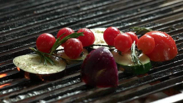Vegetables on grill close up. Eggplant, cherry tomatoes and zucchini.