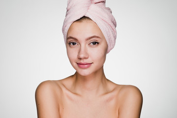 happy woman with a towel on her head on a gray background