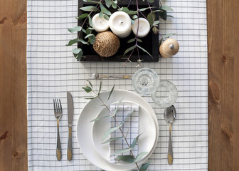 Table setting with branches of eucalyptus