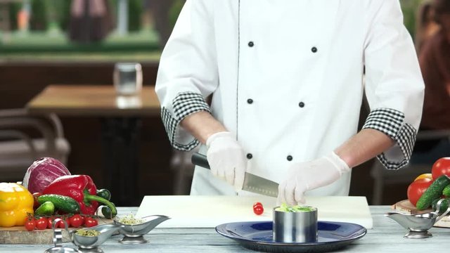 Chef preparing food. Salad with cherry tomato.