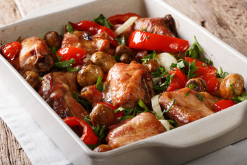Delicious healthy rabbit baked with mushrooms and vegetables close-up in a baking dish on a table. horizontal