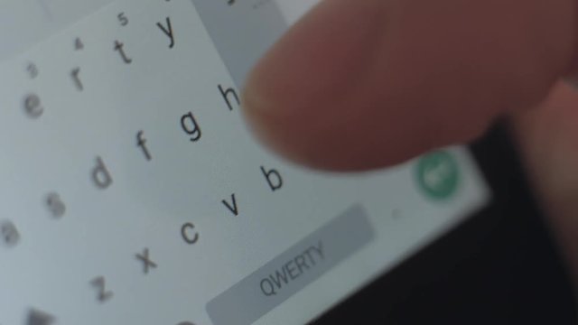macro shoot - male send the message on his smartphone, typing text, close up of letters on the screen digital devise