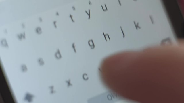 macro shoot - male send the message on his smartphone, typing text, close up of letters on the screen digital devise