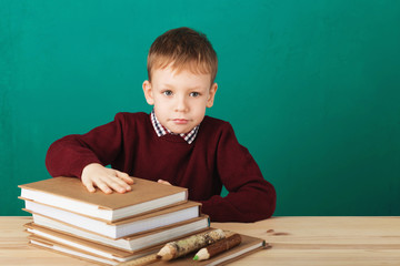 Young boy looking angry shaking his fists tired of school lessons, education. Tiredness stressing overworking children expressive emotional furious mad learning. Back to School.