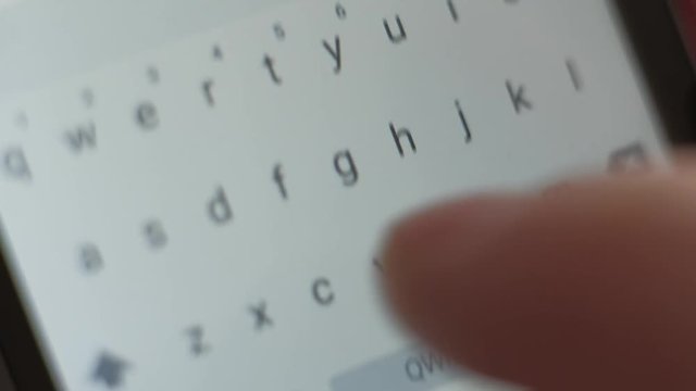 macro shoot - male send the message on his smartphone, typing text, close up of letters on the screen digital devise